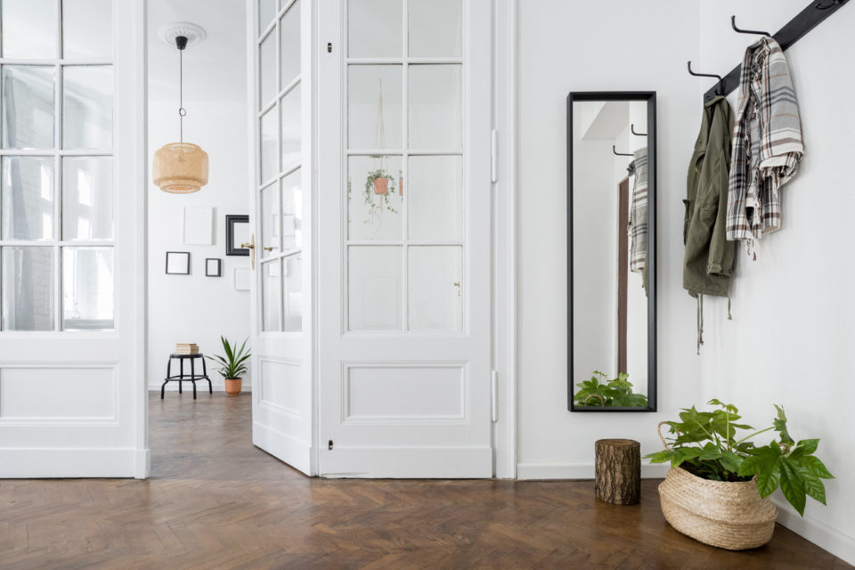 Spacious and stylish home interior with old glass door and wooden parquet