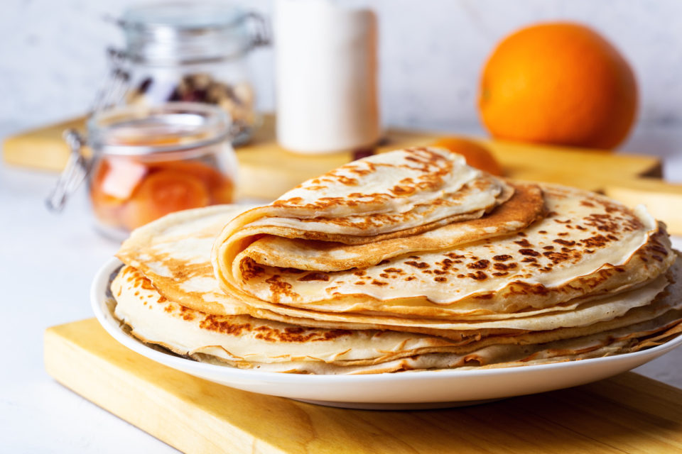 Stack of crepes sitting on plate in kitchen