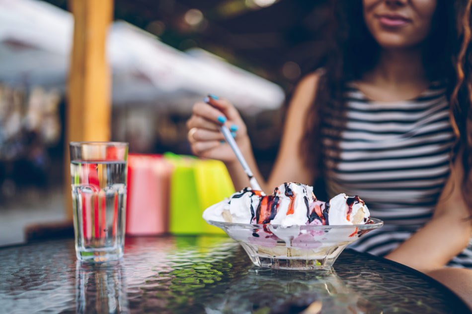 Woman eating a banana split