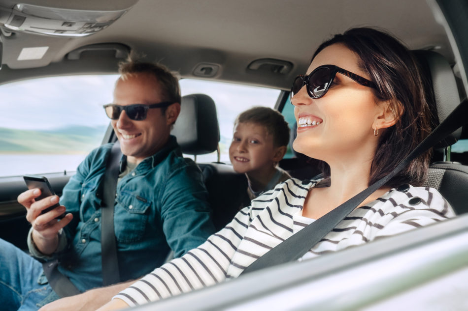 happy family happily driving on a road trip