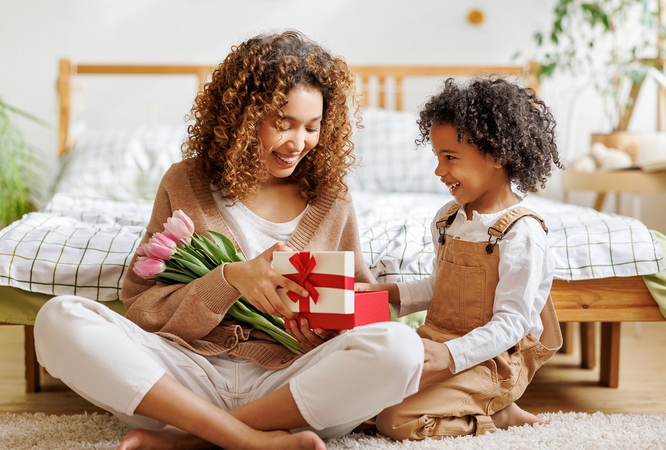 Mother and son opening gift box